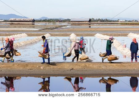 Petchaburi, Thailand - 12th August 2017: Workers Gathering Sea Salt From The Salt Pans.the Farms Oft