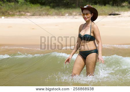 Woman Shape Pretty Enjoy With Bikini Hat And Wave On Beach At Bang Beot Beach, Chumphon Province Tha