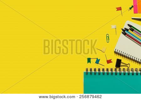 Multiple School And Office Suplies And Gadgets Lying On A Yellow Background. Free Space For Text