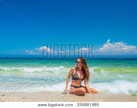 woman sunbathing on the beach summer travel holidays