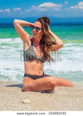 woman sunbathing on the beach summer travel holidays