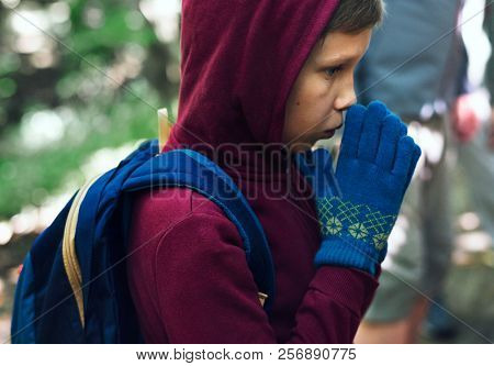 Boy lost and cold in a forest