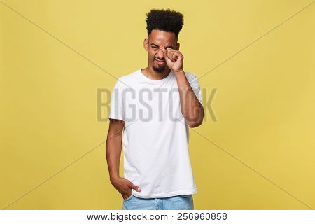 Closeup Portrait Man With Sad Expression, Isolated On Yellow Wall Background. Human Emotions, Body L