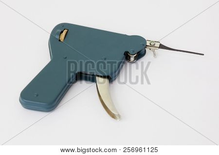 Manual lock pick gun tool for unlocking on white background.