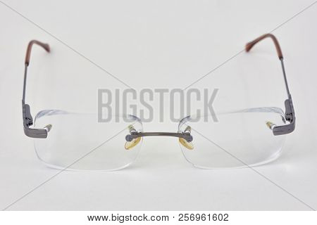 Rimless eye-glasses on white background.