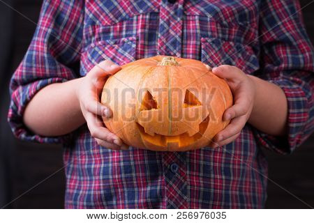 Little Girl With Carved Halloween Pumpkin Or Jack-o-lantern