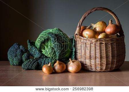 Organic Vegetables - Savoy Cabbage, Broccoli And Golden Onions In A Basket On The Wooden Table. Set 
