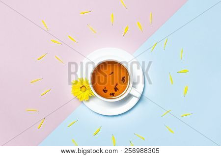 Cup Of Herbal Tea With A Yellow Chrysanthemum On Blue Pink Background Top View Flat Lay. Concept Goo