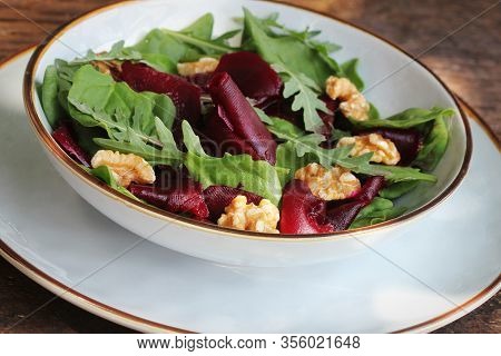 Vegetarian Food. Healthy Beet Salad With Fresh Sweet Baby Spinach, Arugula, Nuts