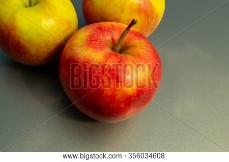 Juicy Ripe Apple Fruits On A Gray Background