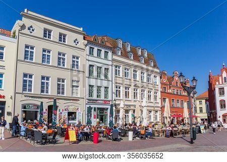 Wismar, Germany - April 19, 2019: People Enjoying The Sun At The Market Square Of Wismar, Germany