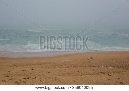 Sea And Sandy Beach In Dense Fog, Autumn Day