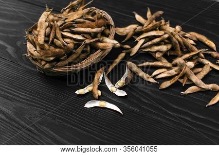 Ripe Soy Pods In Basket On Wooden Dark Background