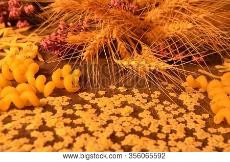Bright Pasta Of Interesting Shapes And Ears Of Ripe Wheat