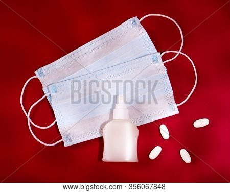 P Revention Of C Oronavirus. Medical Masks, Vitamins, Antiseptic On A Red Background.