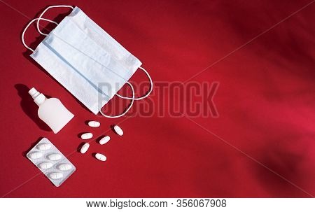 P Revention Of C Oronavirus. Medical Masks, Vitamins, Antiseptic On A Red Background.
