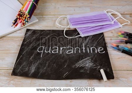 Chalkboard, Pencils And Face Mask On The Table. Quarantine School Concept.