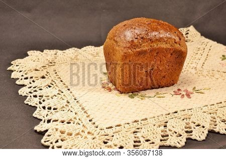 Delicious And Fragrant Bread With Toasted Crust On An Embroidered Linen Napkin