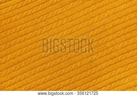 Close Up Background Texture Of Warm Yellow Cable Knitted Wool Jersey Fabric Sweater With Row Braid P
