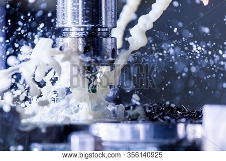 Close-up View Of Vertical Cnc Steel Milling Process With External Water Coolant Streams, Splashes An
