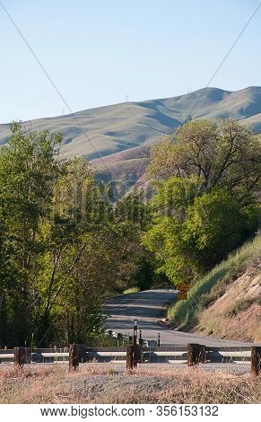Country Road Landscape With Gentle Rolling Hills With A Curved Street.  Taken Near Wenatchee Washing