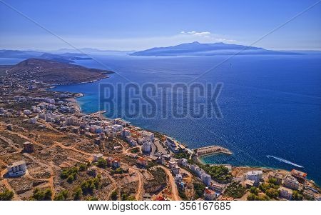 Panoramic Aerial View Of Sarande Beautiful Town In Albania And Corfu Greek Island In The Distance.