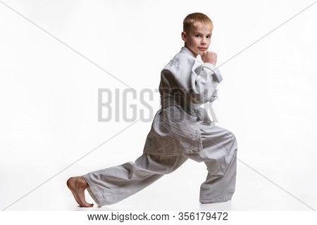 Martial Arts Student Crouches, Stretches His Legs And Looked Into The Frame