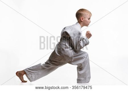 Martial Arts Student Crouches And Stretches His Legs