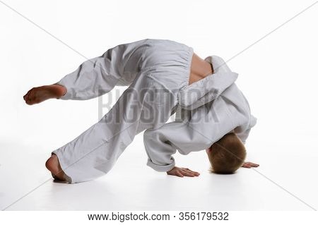 Judo Boy Doing Warm-up Spinning Around Himself While Standing On His Head
