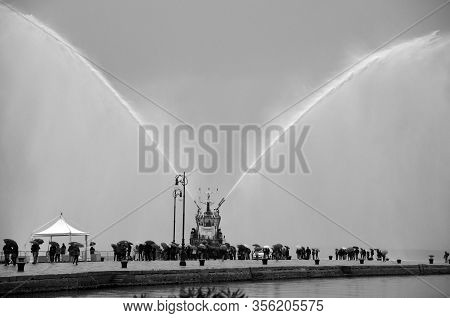 Trieste Italy 05 19 2019: Deneb Tug Boat In Trieste Italy Giving Farewell Salute With Fire Hoses Wit