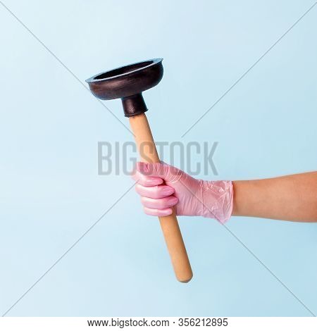 Hand In Pink Glove Holding Domestic Plunger. Concept Of Cosmetology Device For Skin Cleaning And Hom