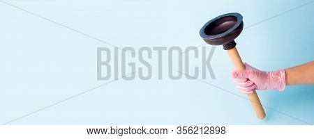 Hand In Pink Glove Holding Domestic Plunger. Concept Of Cosmetology Device For Skin Cleaning And Hom