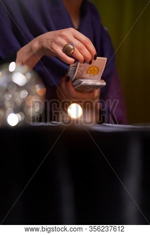 12.02.20. Moscow, Russia. Fortuneteller woman divines on cards at table with candles