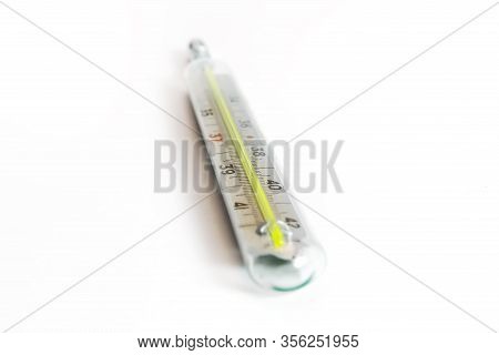Mercury Medical Thermometer Showing High Temperature Close-up On A White Background.