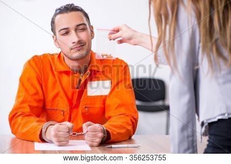 Young man meeting with advocate in pre-trial detention