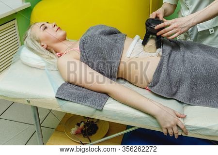 Woman Getting Cryolipolysis Fat Treatment Procedure In Beauty Salon