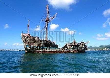 Old abandoned wooden shipwreck on the sea