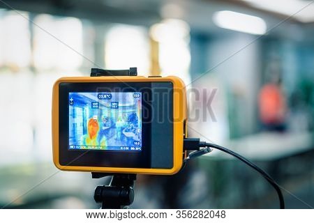 People Waiting For Temperature Check By Thermoscan