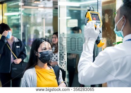 People Waiting For Temperature Check By Thermoscan