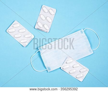 P Revention Of C Oronavirus. Medical Masks, Vitamins On A Blue Background.