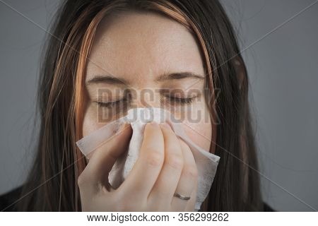 Sneezing, Coughing Or Blowing Nose In A Single Use Paper Towl. Concept Of Catching Cold, Virus Or In