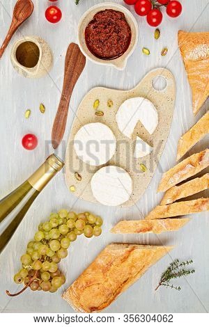 Bottle Of White Wine, Cheese, Bread And Tomatoes For Buffet Party. Traditional French Or Italian Ent