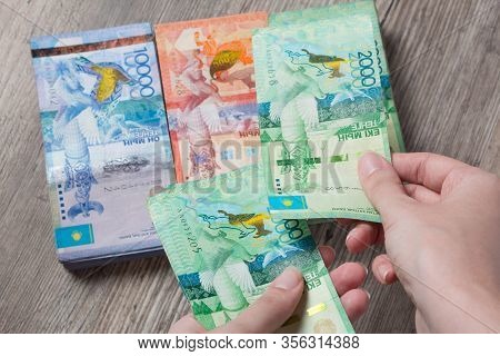 Hands Hold A Lot Of Money. Tenge Kzt. National Currency Of Kazakhstan, Kz. Exchange Rate. Economy, D