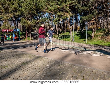 Buchares/romania - 03.17.2020: Young Men Jogging In The Park. People Enjoying A Run In The Alexandru