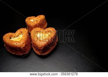 Heart Shaped Sponge Cake. Bakery Products. Black Background.