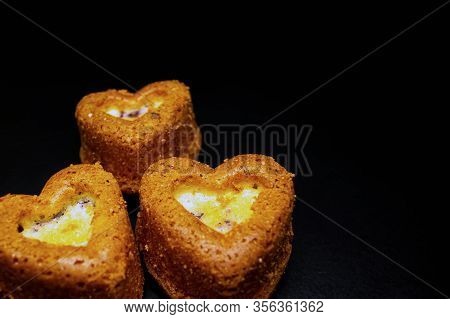 Heart Shaped Sponge Cake. Bakery Products. Black Background.