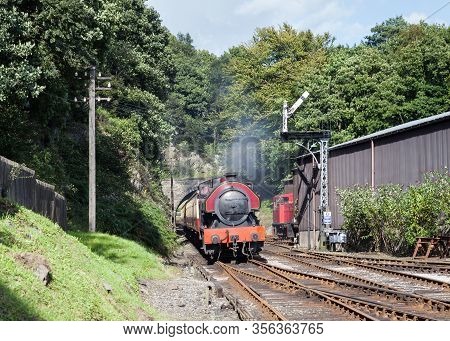Haverthwaite, England - August 8:  A Preserved Steam Locomotive Arrives In Haverthwaite Station On A