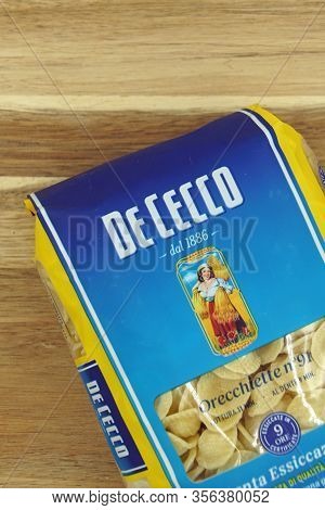Zaandam, The Netherlands - March 17, 2020: Package Of De Cecco Pasta Against A Wooden Background.