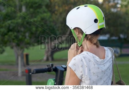 Brisbane, Queensland, Australia - 28th January 2020 : Close Up Of A Woman Lacing A Helmet For Riding