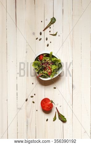 Mixed Salad With Munga Bean Sprouts And Pumpkin Seeds, Top View On Light Boards